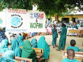 Representatives of USAID and WOFAN distribute hygiene and sanitation materials