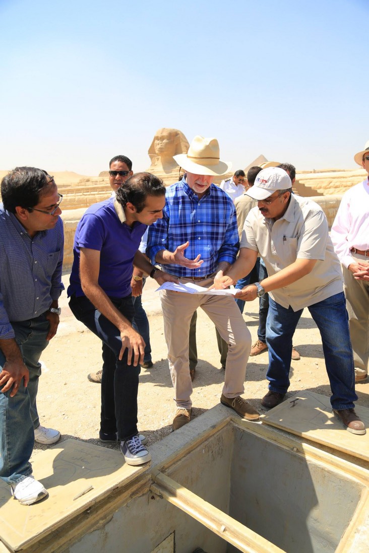 U.S. Ambassador Beecroft and others view a draining pump that protects the Sphinx from groundwater