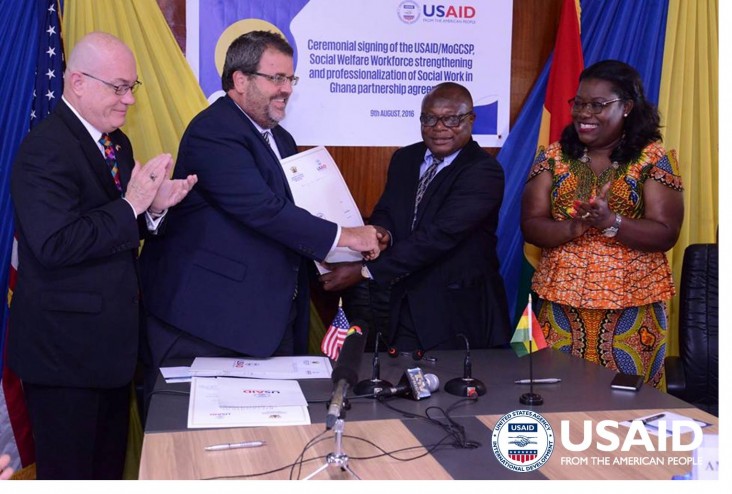 USAID/Ghana Mission Director, Andy Karas exchanges the MOU with the director of Social Welfare 