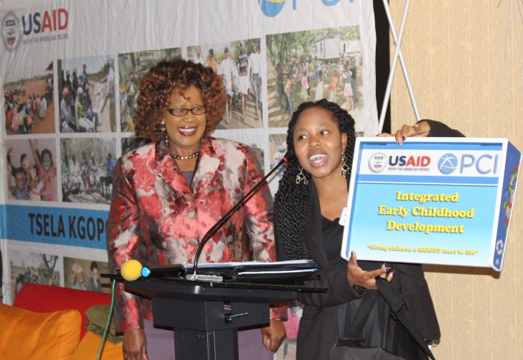 USAID-funded Tsela Kgopo project presents the “Desk Buddy,” a solar-powered portable desk and light, to Botswana's Assistant