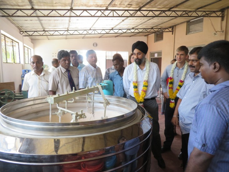 USAID Deputy Assistant Administrator Manpreet Anand examines rice flour processing machinery at Sivanarul Vocational Training an
