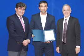 Abdul Raziq Samadi (L), Head of DABS, and William Hammink (R), USAID Mission Director recognized the work of Ehsan Khaibar.