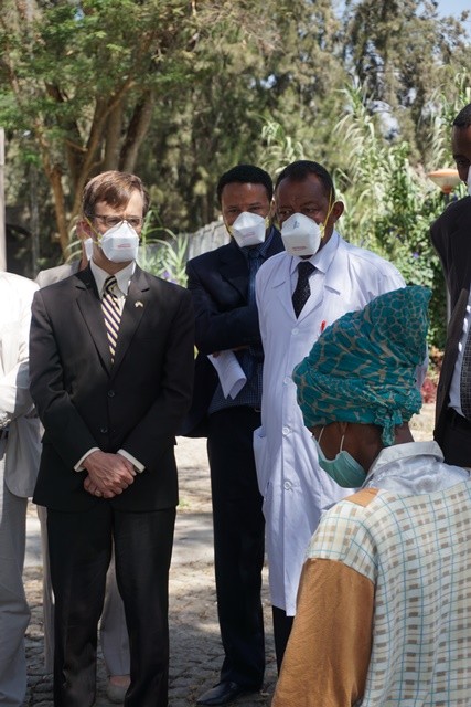 U.S. Deputy Chief of Mission Peter Vrooman talks with a patient undergoing treatment for TB at the ALERT Center in Addis Ababa.