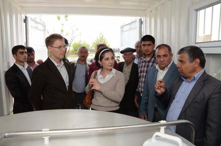 Local residents join USAID staff to tour the facility
