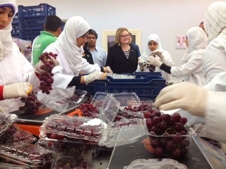 USAID/Egypt Mission Director Dr. Mary C. Ott speaks with employees packaging GlobalGAP and FairTrade certified grapes.