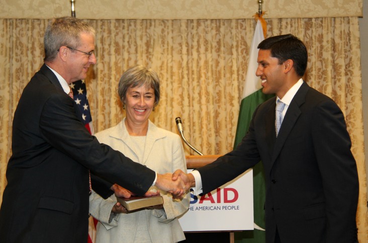 Jonathan Conly and Administrator Shah shake hands following the swearing-in