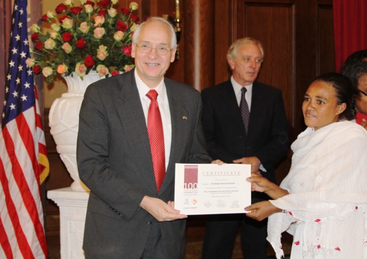 U.S. Ambassador Booth presents certificate to one of the trainees