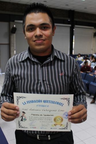 A young man poses with his new certificate