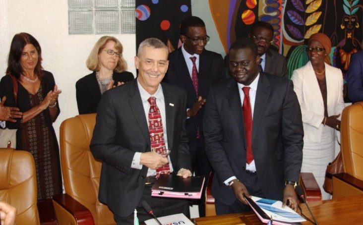 USAID Deputy Assistant Administrator Richard Greene (front left) shakes hands with Khadim Ba (front right), Director General of 