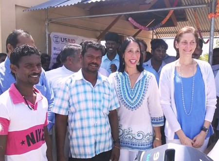 U.S. Ambassador Michele Sison and USAID Mission Director Sherry F. Carlin with local fishermen