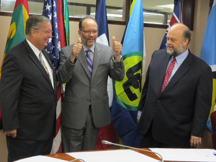 Elated CARICOM Secretary General Ambassador Irwin LaRocque gives a thumbs up following the signing
