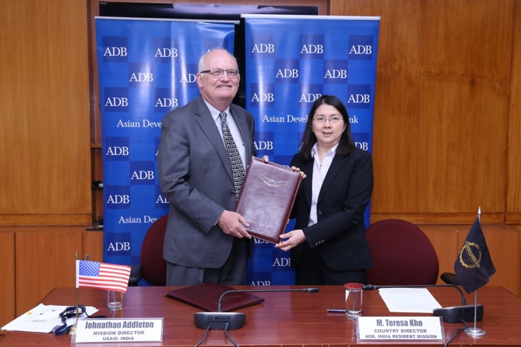 Ambassador Jonathan Addleton and M. Teresa Kho at the signing ceremony.