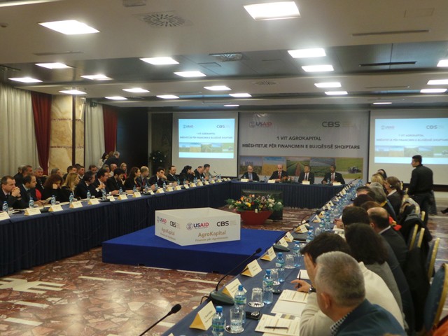 Bank and financial institution representatives are seated in a large conference room 