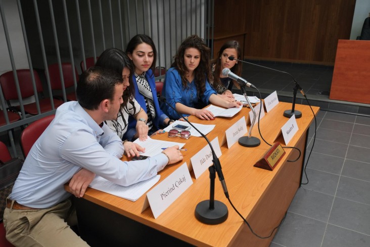 A team of law students compete in a debate at a court