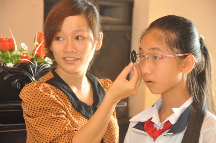 A school girl in Kon Tum tries out her new glasses.