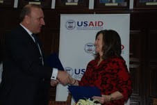 Rector Ibrahim Gashi (left) and USAID Mission Director Maureen A. Shauket (right) formalize an agreement to support improvements