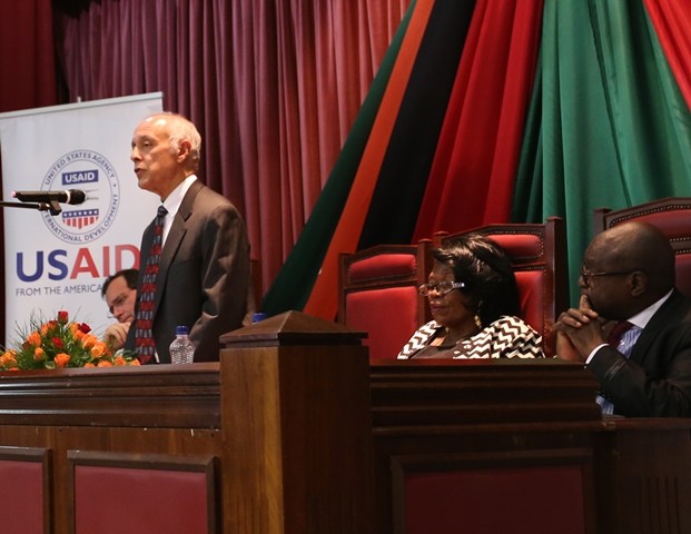 A photo of USAID/Zambia Mission Director Dr. Michael Yates addressing the Zambian Parliament advocating against GBV.