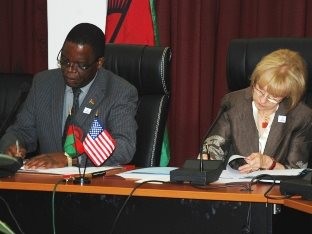 Malawi's Minister of Finance Dr. Ken Lipenga and U.S. Ambassador to Malawi Jeanine Jackson sign bilateral assistance agreements.