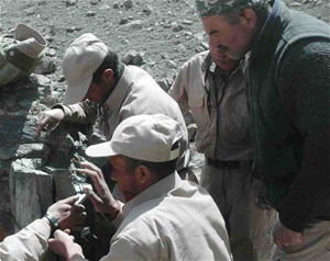 Kormal (top center) works with other rangers to set up a camera trap in the Wakhan. Under his leadership, they became the first 