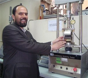 Engineer M. Eshaq, the senior lab manager at the Kabul Central Laboratory, demonstrates one of the quality control instruments t