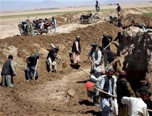 A team of laborers cleans a canal in Daman District, Kandahar.