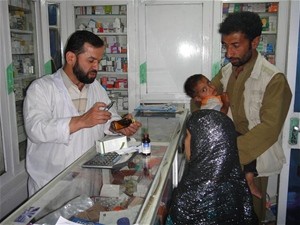 Pharmacist Hasham provides medication counseling to parents for their sick child.