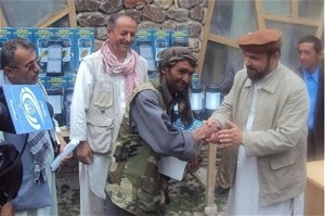 Badakhshan Governor Shah Wali Adeeb presents a lantern to a recipient, while Eng. Pir Mohammad Yaftali, MRRD Director for Badakh