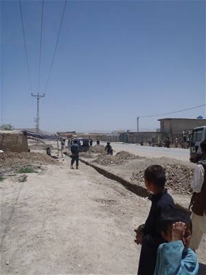 Sherzad, a police officer, keeping watch as he escorts CADG personnel to a project site in Qalat, Zabul Province