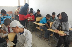 Shahla Dastyar observing her student, Mursal Sarwari, who is in tum teaching students at a high school in Kabul.