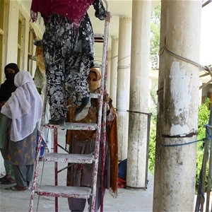 Women painting and plastering a veranda at a girls’s school on the outskirts of Jalalabad.