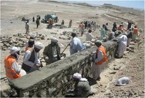 Workers building a retaining wall around the Segana Reservoir in Zarghun Shar District.