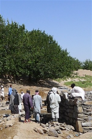 Residents of Charborjak Village working to repair the route leading to a major market.