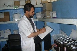 Pharmacist Zakhi Ahmad Qiami records medicines on a stock card in the pharmacy at the Indira Gandhi Children’s Hospital in Kabul