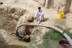 Abdul Manan and the water pump provided to him by USAID’s ACAP program.