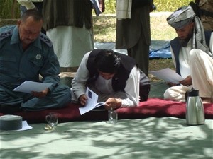 Attendees of the Loya Jirga in Kahmard District in Bamyan Province examining the proposal for a 164 kilometer road that is plann