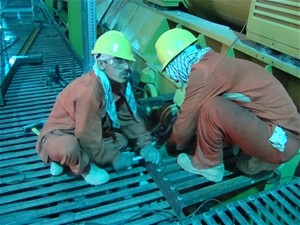 Trainees at the Tarakhil power plant install a fabricated platform that provides access to the turbines and other machinery. The