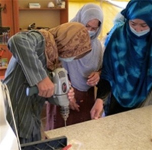 Women learn vocational skills at the Afghan Women’s Initiatives organization through funding and support from USAID.