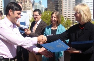 With Washington, D.C. in the background, Mirwais Attaulhaq (left) is congratulated by a representative of the International Lead