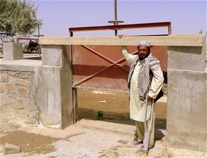 Paktika Province farmer, Haji Lal Khan, stands at a water gate connecting the Paltu River intake with the Sra Kala can-al.