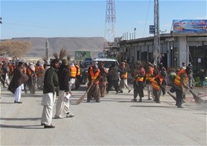 Working together, volunteers enthusiastically swept their city and collected trash.