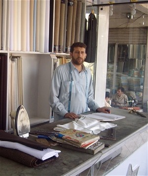 A young man learns how to run a tailoring business as part of an apprenticeship program for day laborers in Jalalabad.