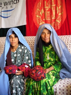 Members of the silkworm production display their silk-embroidered products.