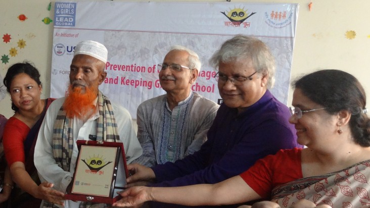 Abdul Majid, second from left, is recognized for his commitment to educating his three daughters.