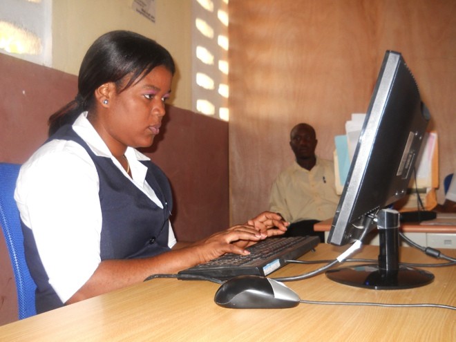 Municipal staff process tax payments on software locally developed for the Haitian context.