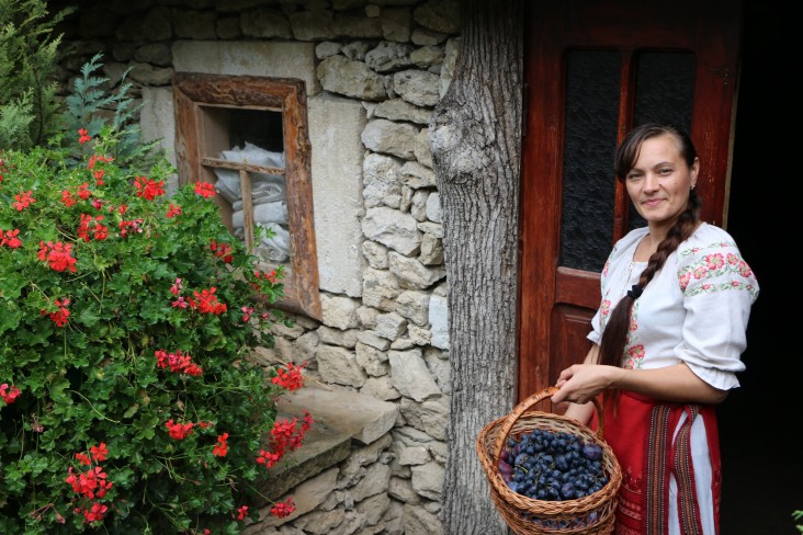 Falaga at the "Eco-resort Butuceni" touristic center with a basket of locally grown plums and grapes.