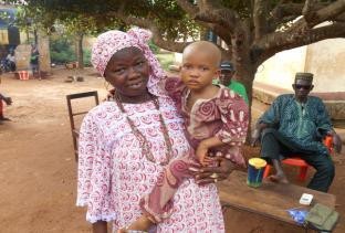 Community Health Worker Holds Baby