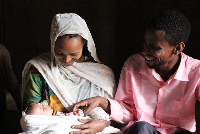 Nefisa and her husband with their 2-week-old daughter.