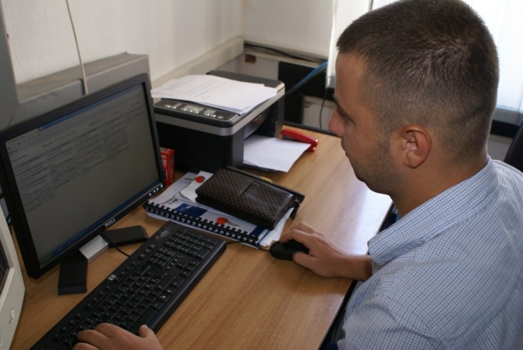 A man works in front of a computer screen