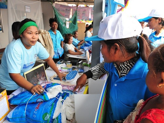 PMI/USAID workers hand out information on malaria and mosquito nets for protection.
