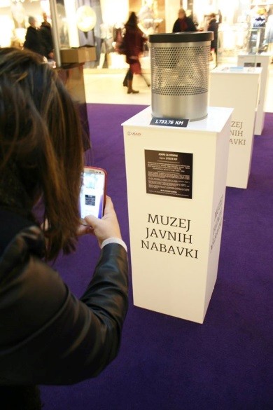  Citizen takes photos of $938 wastebasket bought by government, during "We Pay the Price" campaign in Sarajevo.